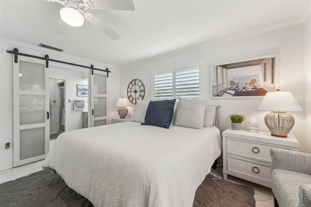 tiled bedroom featuring a barn door, ceiling fan, and ornamental molding