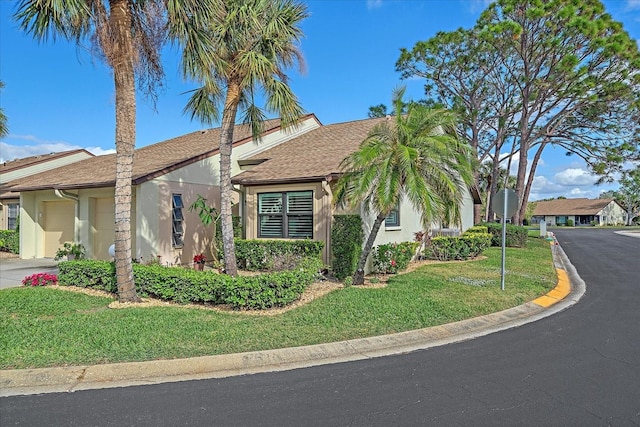 view of front of home featuring a garage and a front lawn