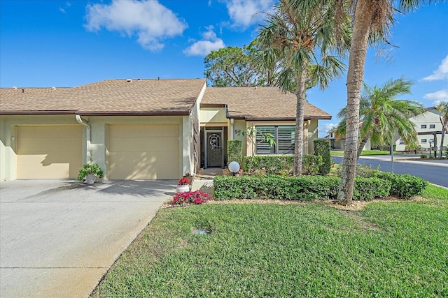 ranch-style house with a garage and a front yard