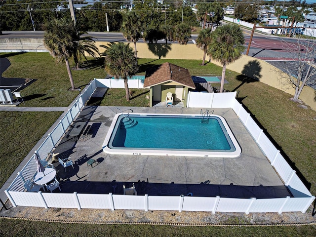 view of pool with a lawn and a patio