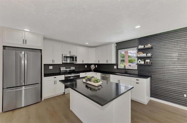 kitchen featuring light hardwood / wood-style flooring, sink, stainless steel appliances, and white cabinets