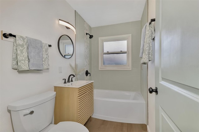 full bathroom with wood-type flooring, toilet, shower / bathing tub combination, and vanity