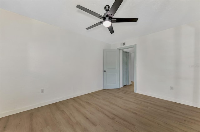 empty room with light hardwood / wood-style flooring and ceiling fan