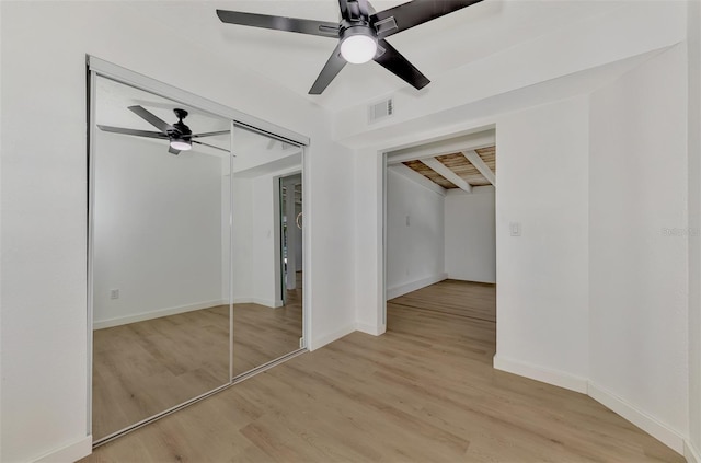 unfurnished bedroom with ceiling fan, a closet, and light hardwood / wood-style floors