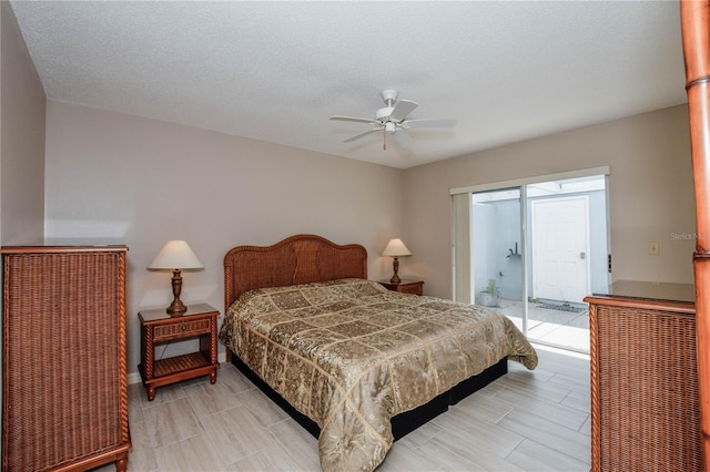 bedroom with access to exterior, a textured ceiling, and ceiling fan