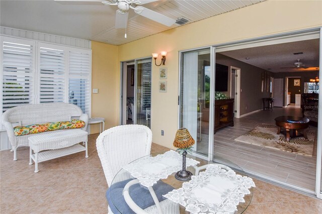 sunroom / solarium with visible vents and a ceiling fan