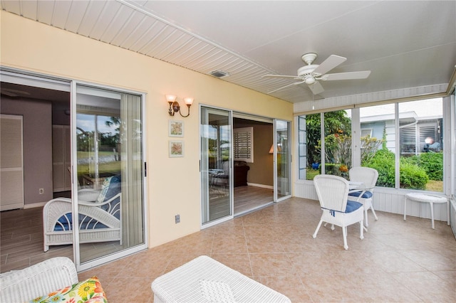 sunroom / solarium with visible vents and a ceiling fan