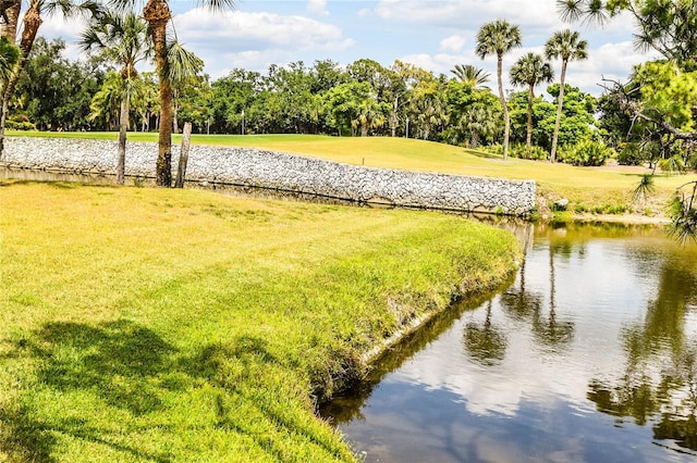 view of community with a lawn and a water view