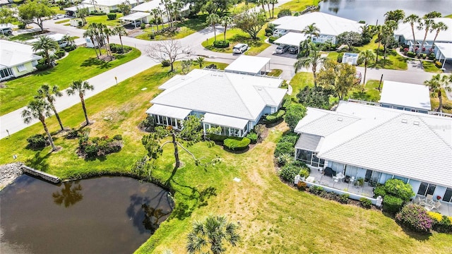 drone / aerial view featuring a residential view and a water view