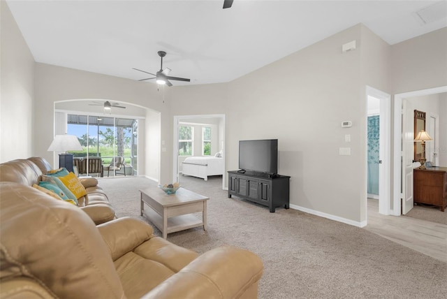 carpeted living room featuring a ceiling fan and baseboards