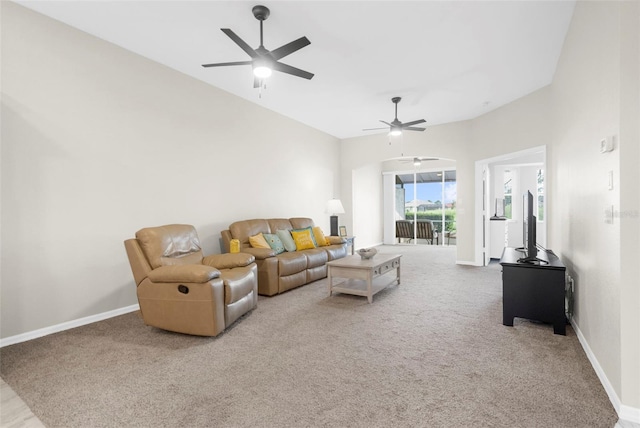 carpeted living area featuring ceiling fan and baseboards