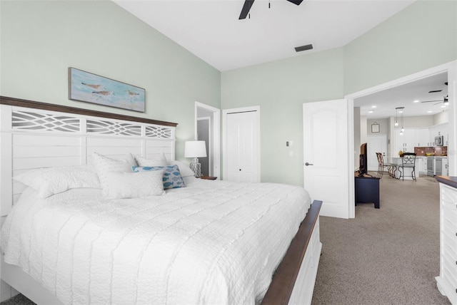 carpeted bedroom with ceiling fan, a closet, and visible vents