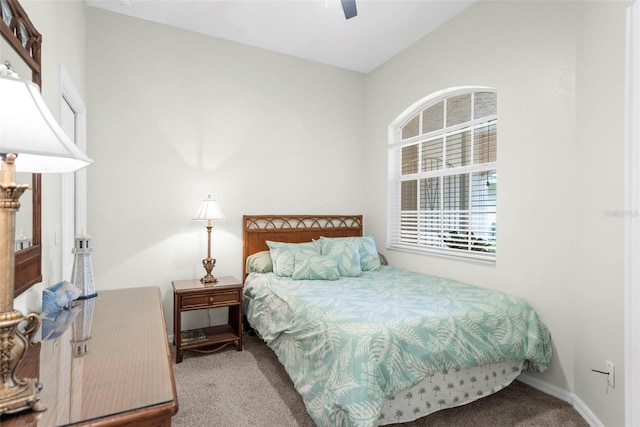 carpeted bedroom with lofted ceiling, ceiling fan, and baseboards