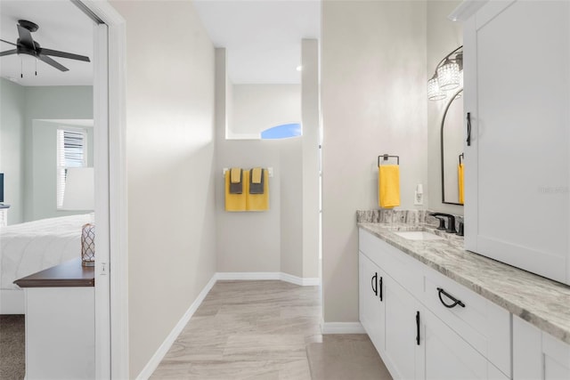 bathroom with baseboards, a ceiling fan, connected bathroom, and vanity