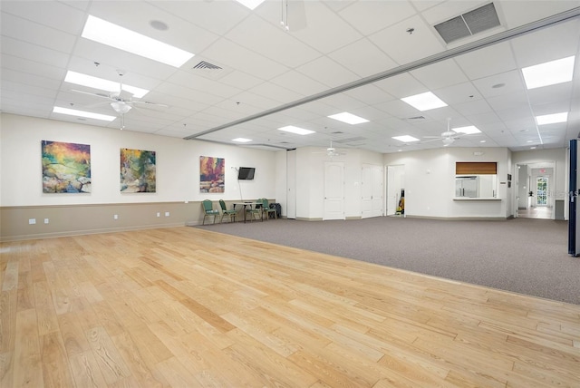 interior space featuring ceiling fan, wood finished floors, and visible vents