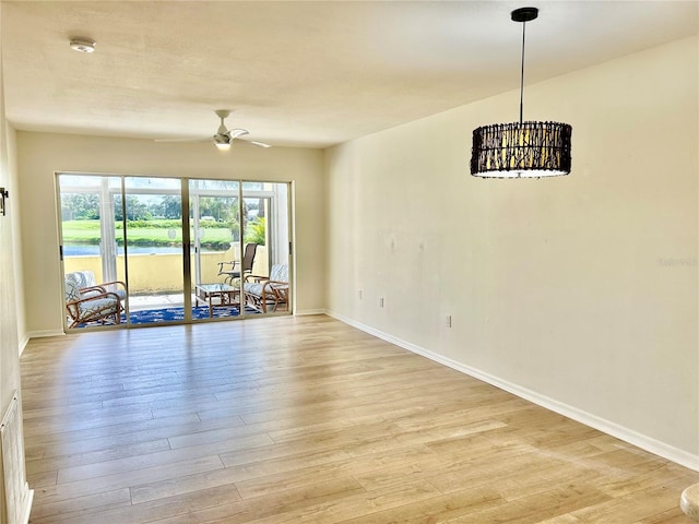 empty room featuring ceiling fan and light hardwood / wood-style flooring