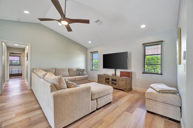 living room featuring lofted ceiling, ceiling fan, and plenty of natural light