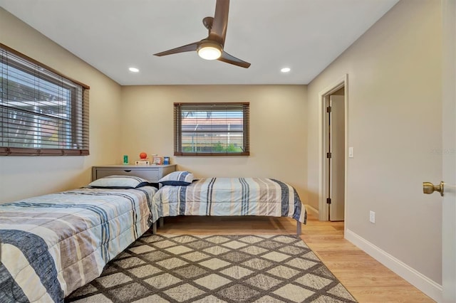 bedroom with light hardwood / wood-style flooring and ceiling fan