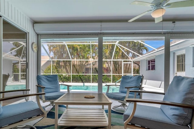 sunroom / solarium featuring ceiling fan