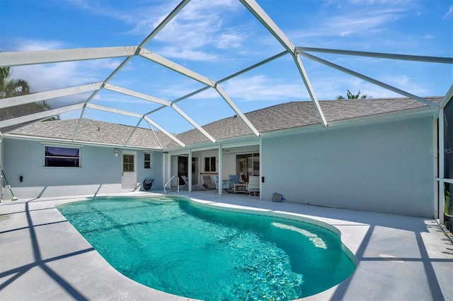 view of pool with a lanai and a patio