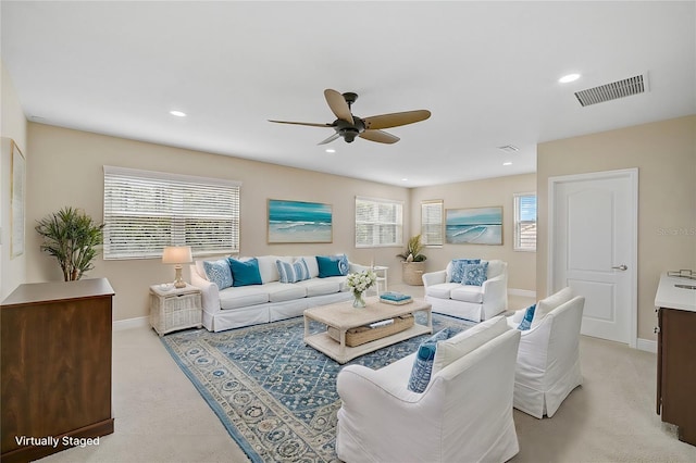 living room with light colored carpet and ceiling fan