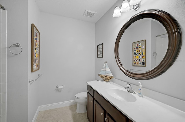 bathroom with vanity, a shower, and toilet