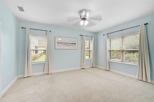 empty room with light carpet and ceiling fan