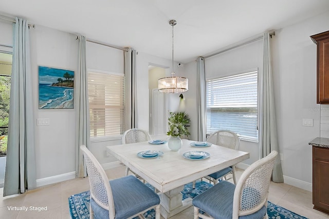 dining space with an inviting chandelier, light tile patterned floors, and plenty of natural light