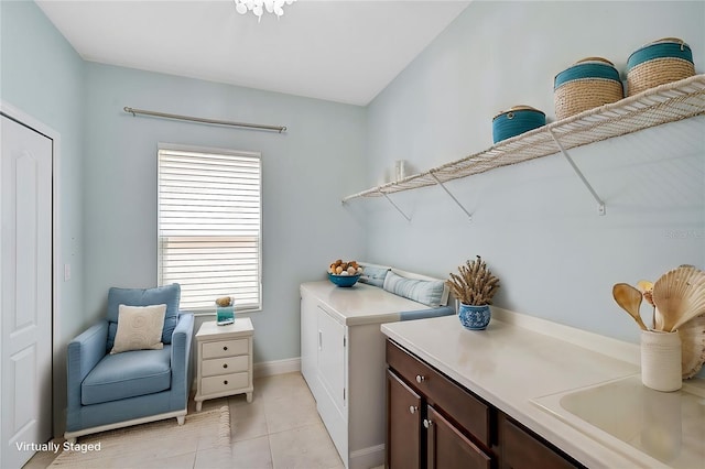 laundry room with light tile patterned floors, sink, and cabinets