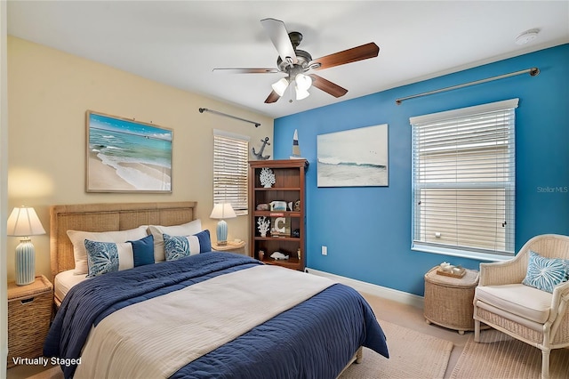 bedroom featuring light carpet and ceiling fan