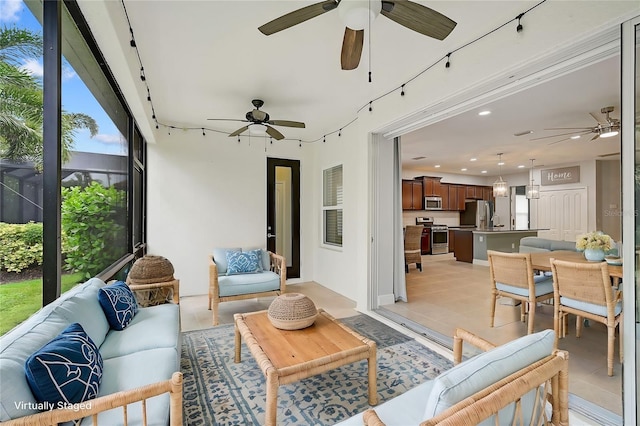 living room featuring light tile patterned flooring and ceiling fan