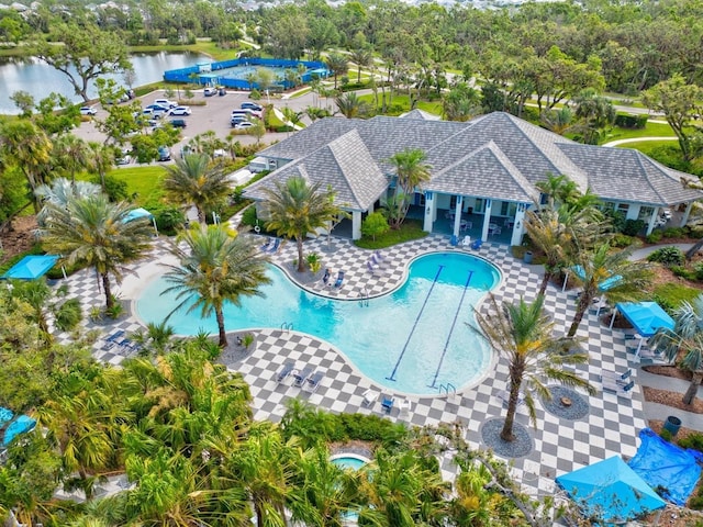 view of pool with a patio and a water view