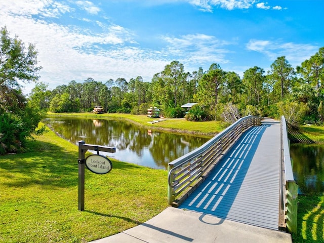 surrounding community featuring a water view and a yard