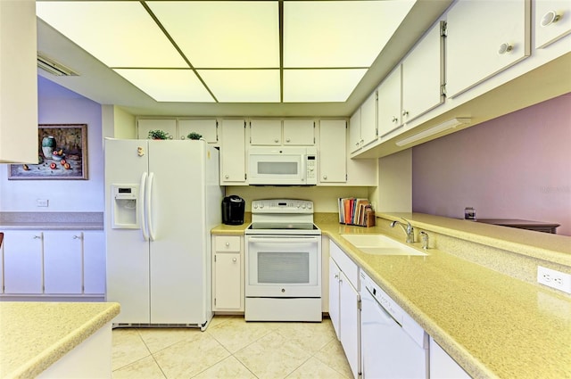 kitchen with white appliances, light tile patterned floors, white cabinetry, and sink