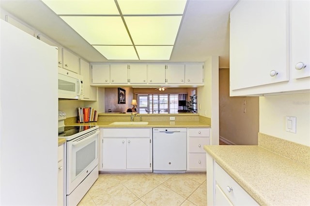 kitchen featuring sink, light tile patterned floors, white appliances, and white cabinetry