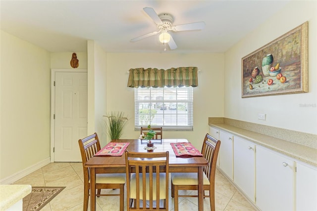 tiled dining area featuring ceiling fan