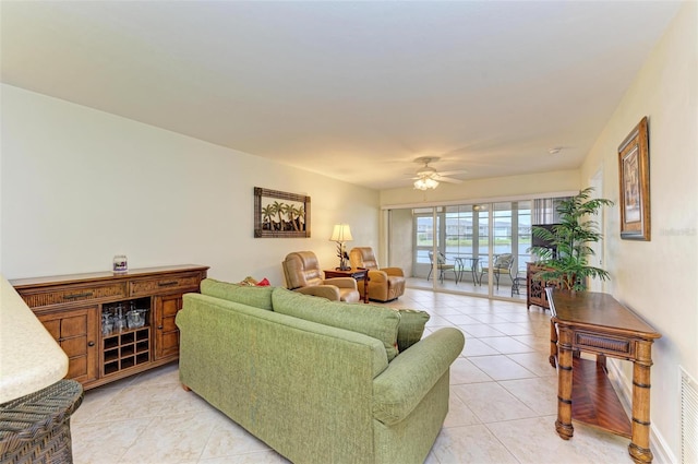 living room with light tile patterned floors and ceiling fan