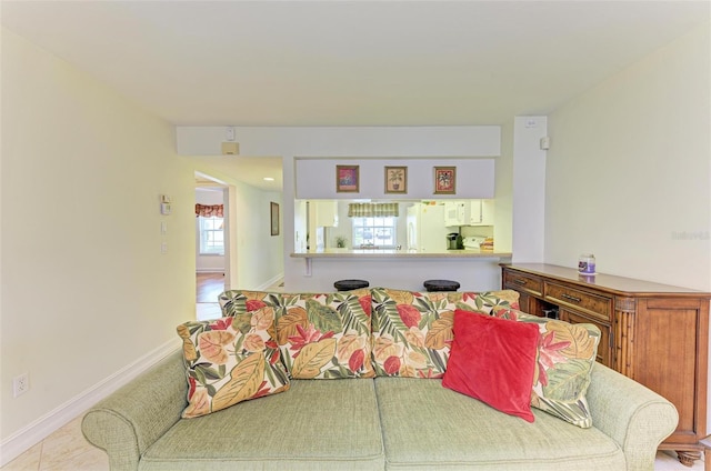 tiled living room featuring a wealth of natural light