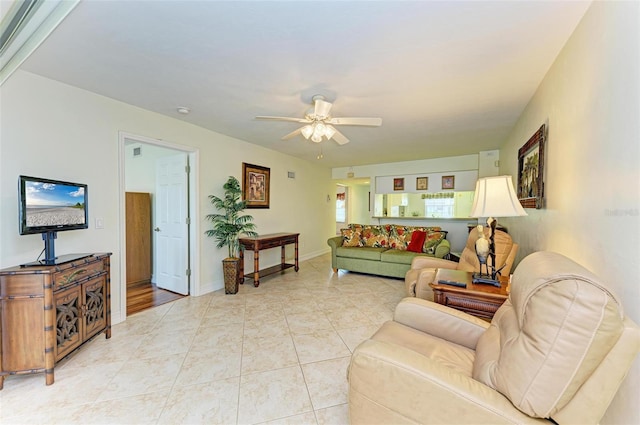 tiled living room with ceiling fan