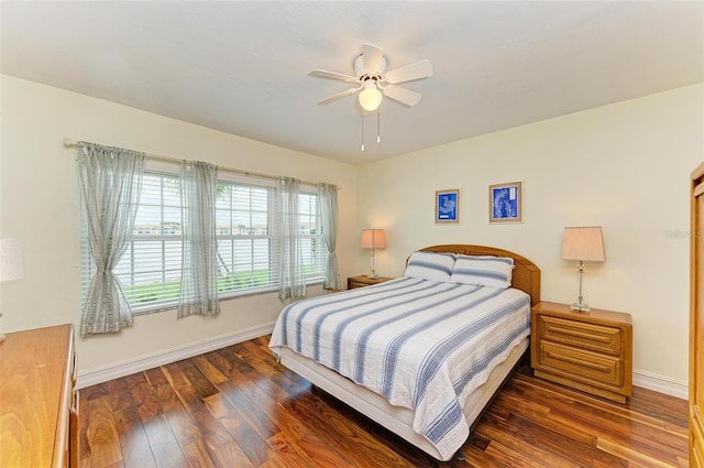 bedroom with ceiling fan and dark hardwood / wood-style flooring