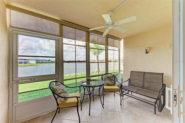 sunroom / solarium with a water view, ceiling fan, and plenty of natural light