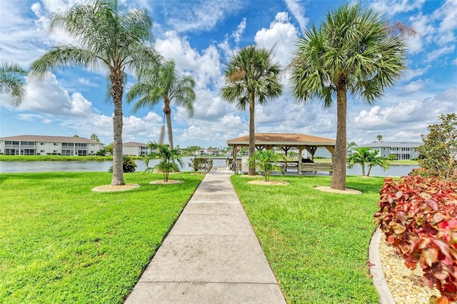 view of home's community featuring a water view and a yard