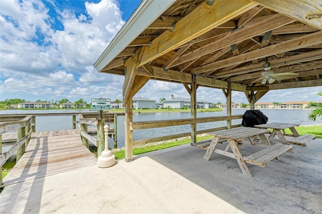 view of patio / terrace featuring a water view and ceiling fan