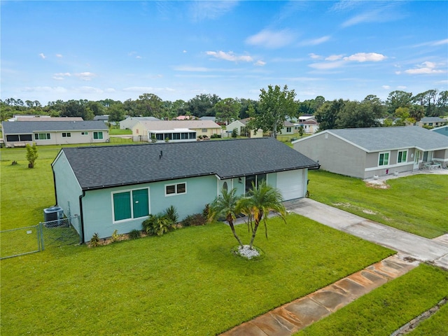 ranch-style house featuring central AC and a front yard