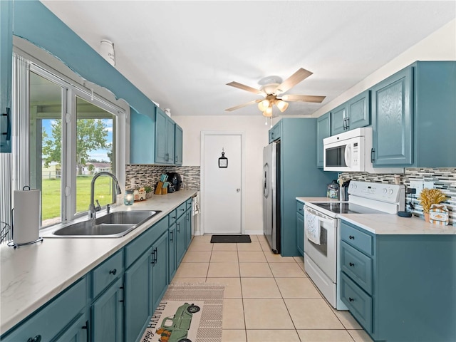 kitchen with light tile patterned flooring, tasteful backsplash, sink, white appliances, and ceiling fan