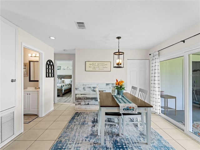 dining room featuring light tile patterned floors and a notable chandelier