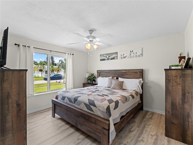 bedroom with light wood-type flooring and ceiling fan