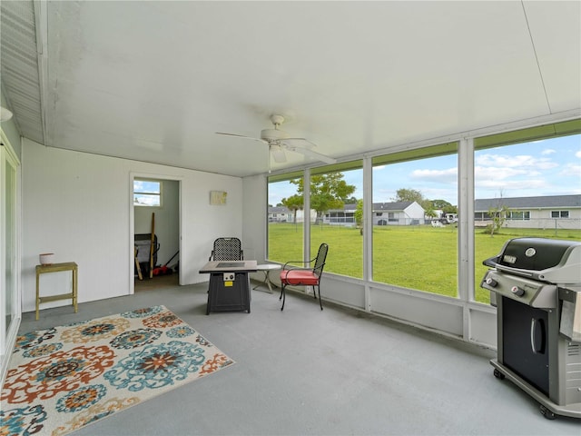 sunroom / solarium featuring ceiling fan