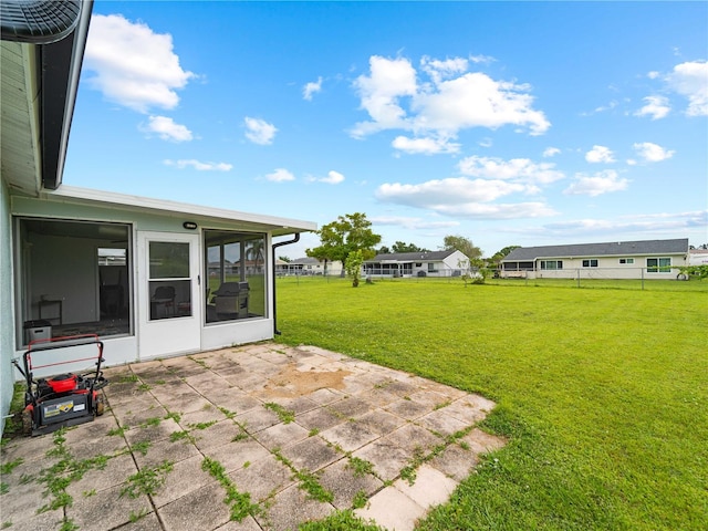 view of yard with a sunroom and a patio