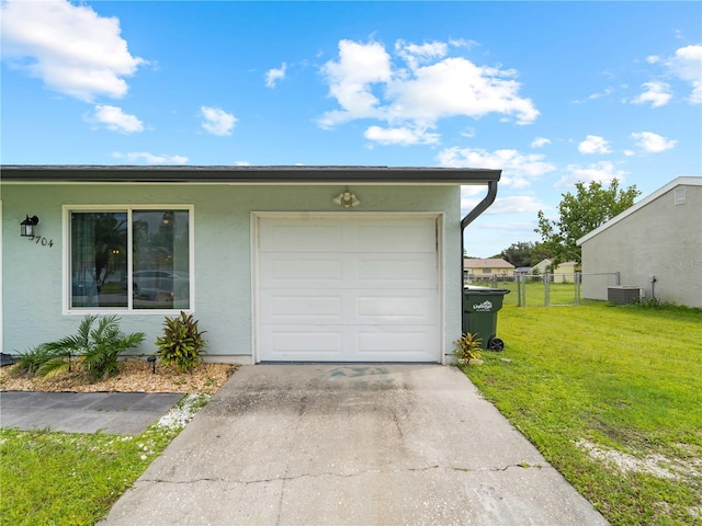 view of front of property with a front yard and a garage